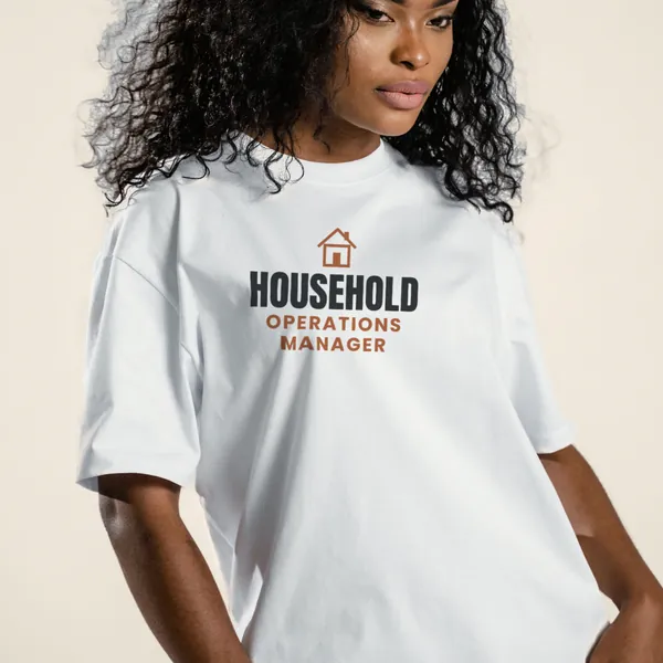 Model wearing a white "Household Operations Manager" graphic tee, front view